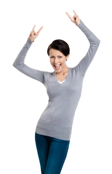 Glad pretty woman puts her hands up with two fingers pointed up — Stock Photo, Image