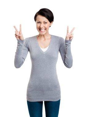 Smiley woman shows victory sign with two hands clipart