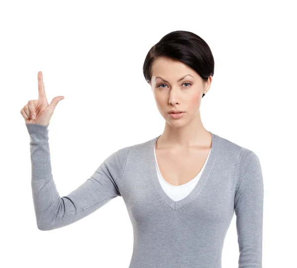 Mujer joven muestra dedo índice, signo de atención — Foto de Stock
