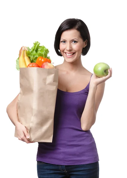 Mulher bonita com o pacote cheio de diferentes alimentos saudáveis — Fotografia de Stock
