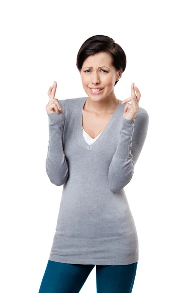 Worried woman shows crossed fingers — Stock Photo, Image