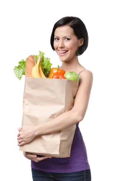 Belle fille avec le paquet de fruits et légumes — Photo