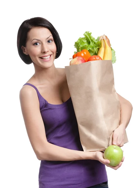 Vegetarisk ung kvinna med paketet full av olika hälsosamma livsmedel — Stockfoto