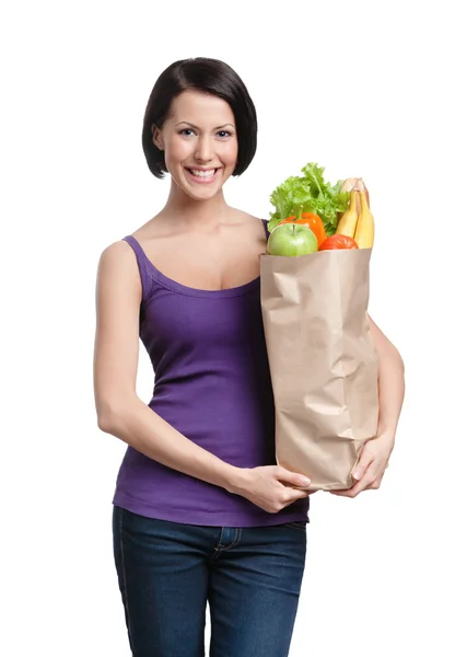 Muchacha atractiva con el paquete de frutas y verduras. Construyendo figura perfecta — Foto de Stock