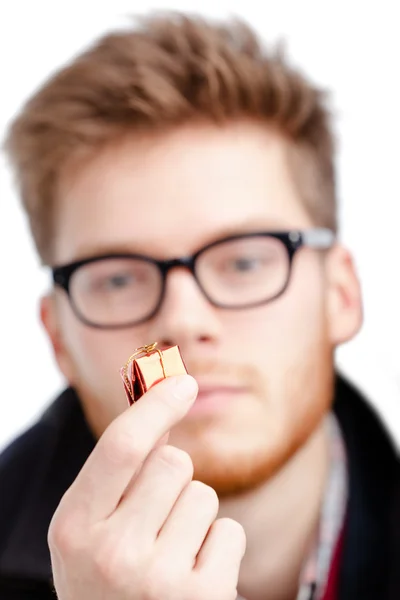 Man holds small toy present — Stock Photo, Image