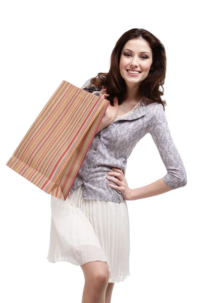 Mujer feliz mantiene a rayas bolsa de regalo de papel —  Fotos de Stock