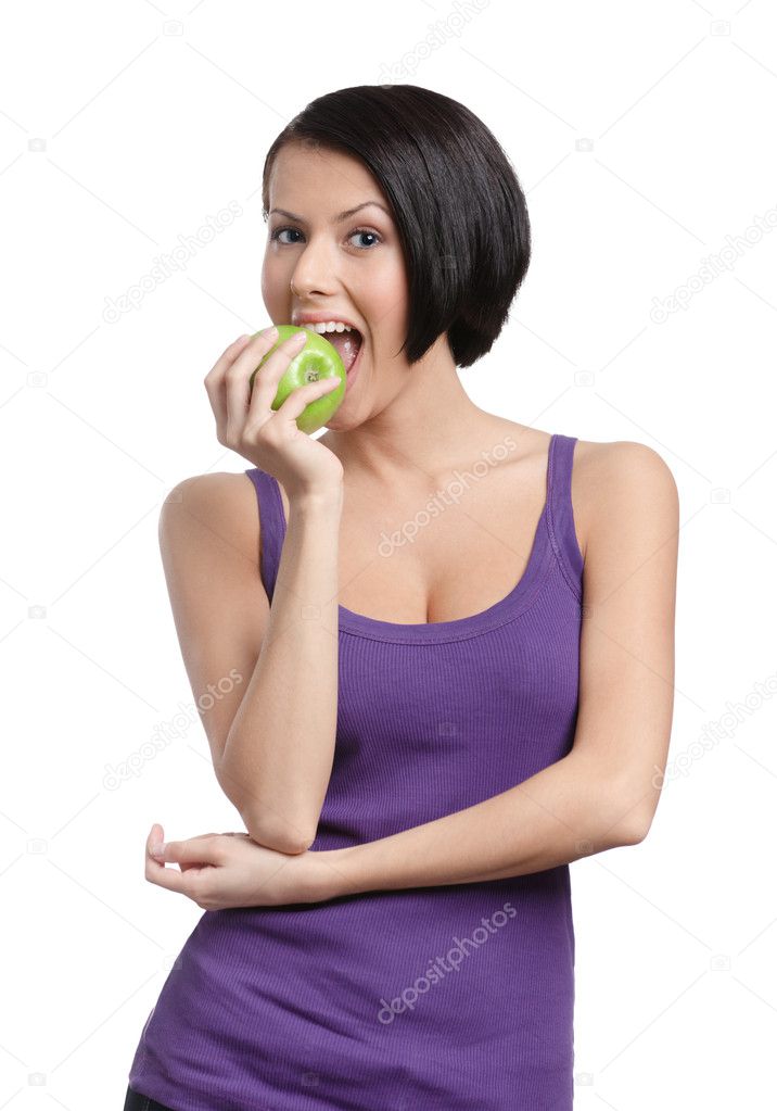 Young lady tastes a green apple