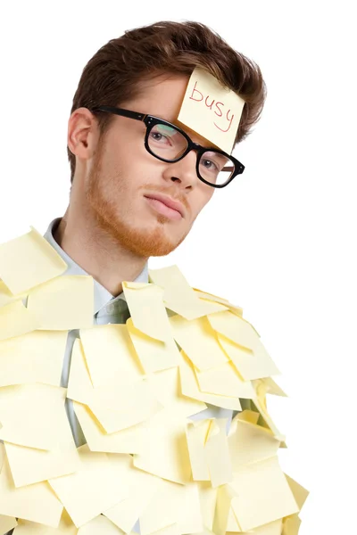 Young man with a sticky note on his face, covered with yellow stickers — Stock Photo, Image
