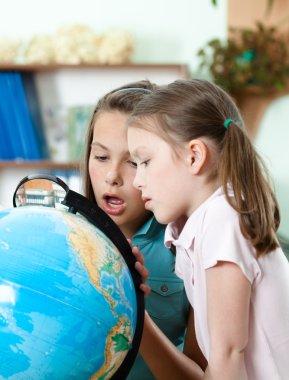 Pupils look at the globe in wide-eyed astonishment clipart