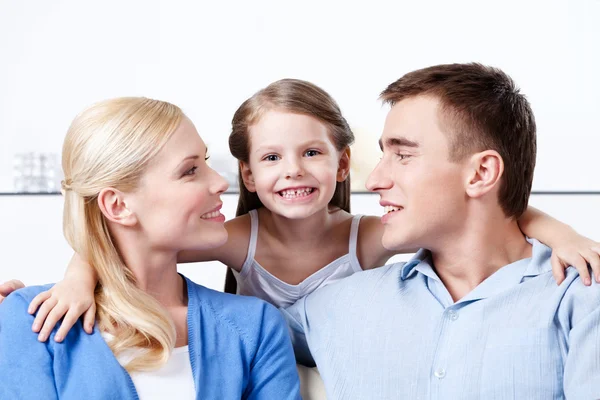Happy family embrace each other on the coach — Stock Photo, Image