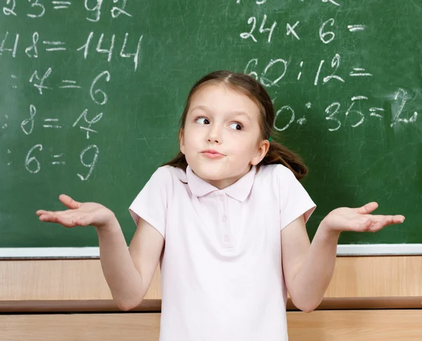 Pupil doesn't know the answer and spreads her arms — Stock Photo, Image