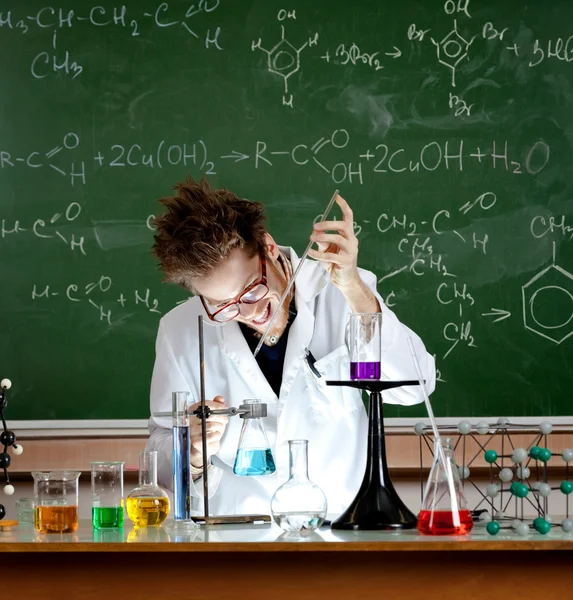 Mad professor holds an experiment — Stock Photo, Image
