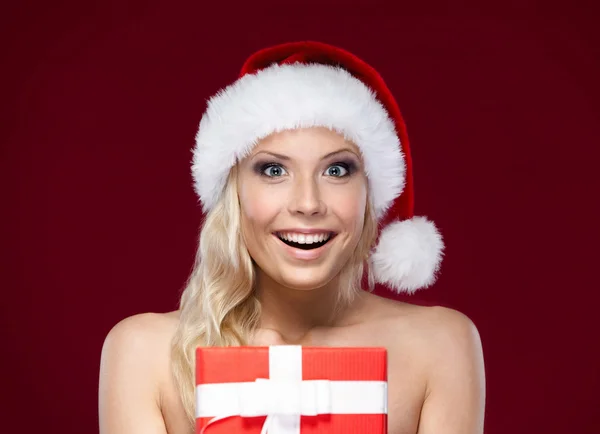Pretty woman in Christmas cap hands present — Stock Photo, Image