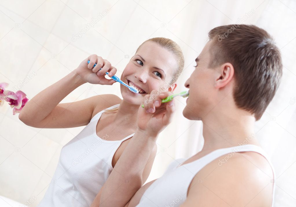 Husband and wife brush teeth