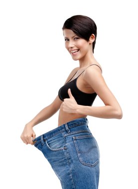 Slender woman wearing enormous jeans
