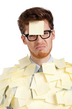 Unhappy young man with a sticky note on his face, covered with yellow sticky notes clipart