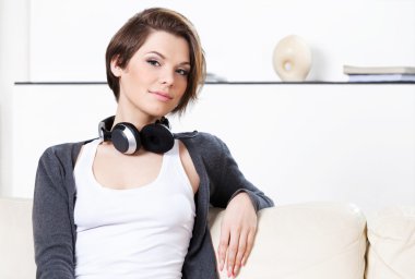 Woman with headphones is going to listen to music clipart