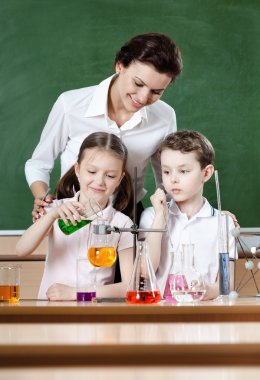 Little pupils study chemical liquids clipart