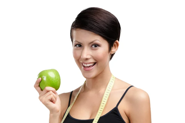 Dívka s flexibilní vládce a zelené jablko — Stock fotografie