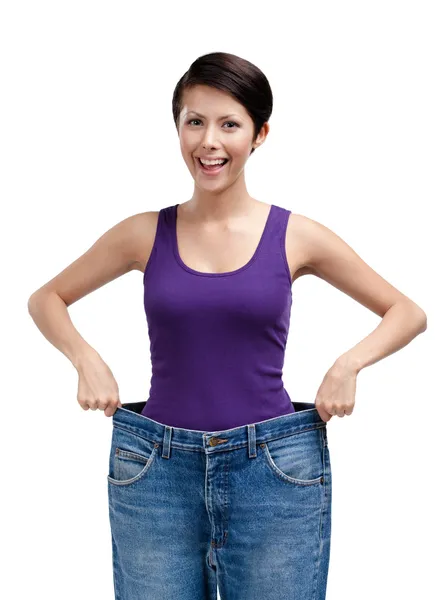 Slender woman wearing huge jeans — Stock Photo, Image