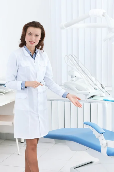 Assistente do dentista mostra cadeira do dentista — Fotografia de Stock