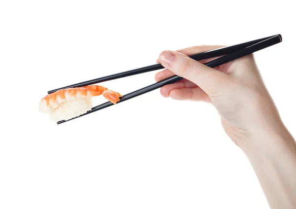 Ręka trzyma sushi z pałeczkami — Zdjęcie stockowe