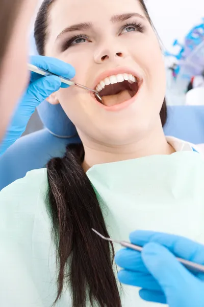 Tandläkaren undersöker det muntliga hålet av en ung patient — Stockfoto