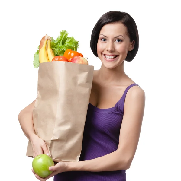 Hezká mladá žena s balíček plný různých zdravé výživy — Stock fotografie