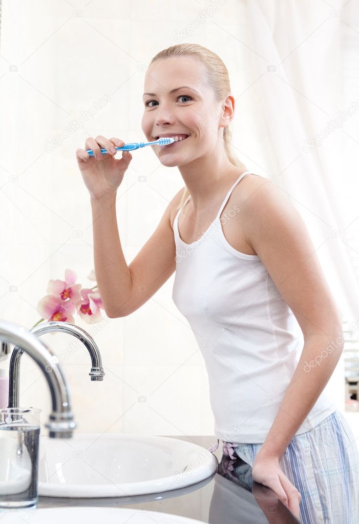 Beautiful woman brushes her teeth