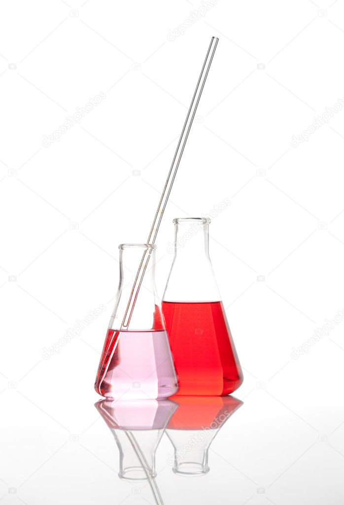 Two conical chemical flasks with a red liquid
