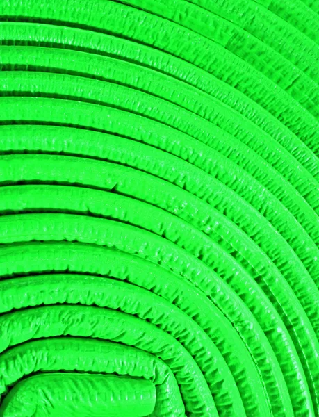 Abstraktes unebenes rundes Material, grüne Rolle. — Stockfoto