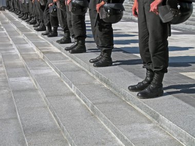 Police cordon in black uniform with hard hat (helmet), security. clipart