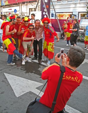 Sport fans from Spain in Euro 2012 football fun zone, Kiev. clipart