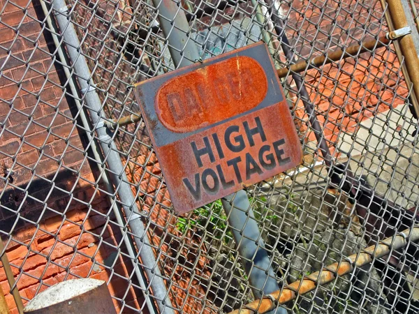 Danger - high voltage as warning message on vintage signboard. — Stock Photo, Image