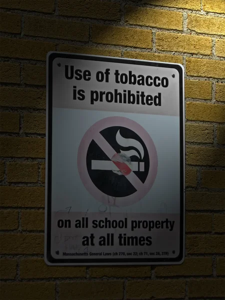 Use of tabacco prohibited in all schools as message on sigbboard. — Stock Photo, Image