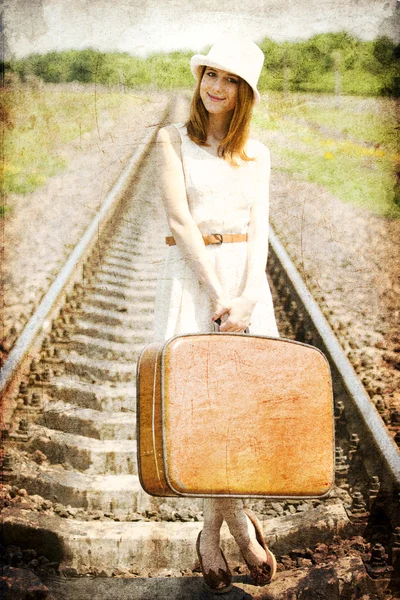 Young fashion girl with suitcase at railways. — Stock Photo, Image