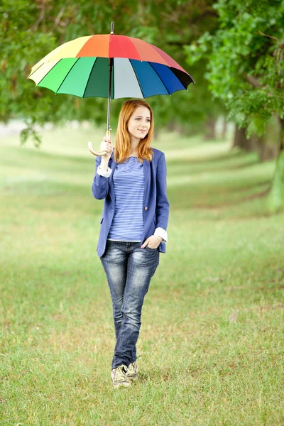 Young fashion girl with umbrella at spring outdoor. — Stock Photo, Image