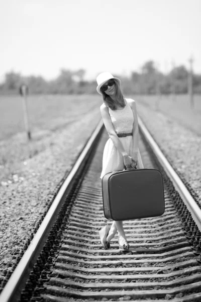 Young fashion girl with suitcase at railways. — Stock Photo, Image
