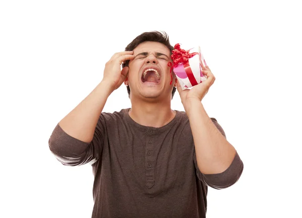 A angry man holding present box on white background. — Stock Photo, Image