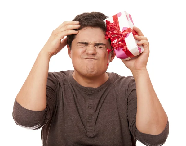 Un hombre enojado sosteniendo la caja presente sobre fondo blanco . — Foto de Stock