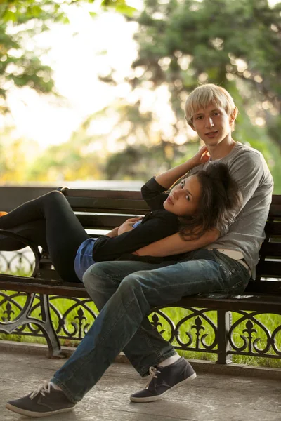 Young couple on the bench at the street. — Stock Photo, Image