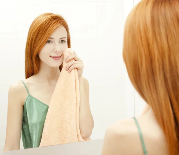 Surprised young woman in bathroom — Stock Photo, Image