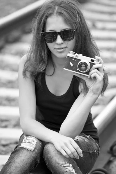 Teen girl with camera at railways. — Stock Photo, Image