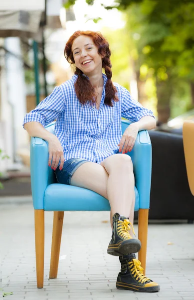 Funny hipster girl in chair on the street — Stock Photo, Image