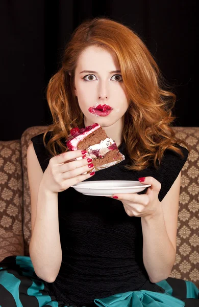 Redhead girl eating cake — Stock Photo, Image
