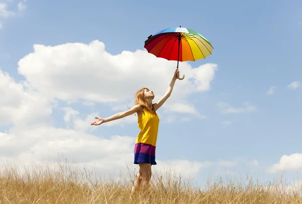 Girl with umbrella at meadow. — Stock Photo, Image