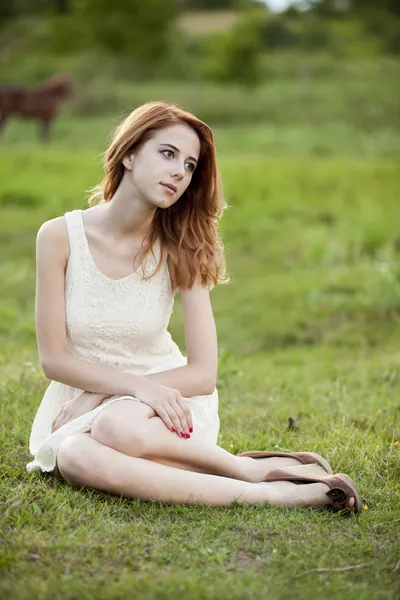 Redhead girl at green grass at village outdoor. — Stock Photo, Image