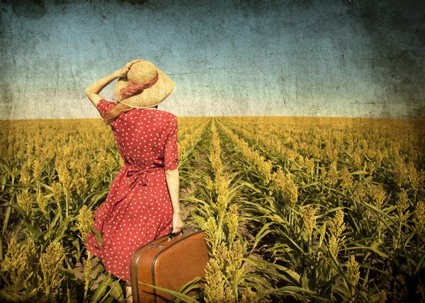Redhead girl with suitcase at corn field. — Stock Photo, Image