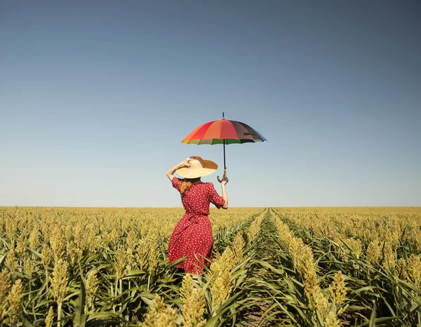 Girl with umbrella at corn field — Stock Photo, Image