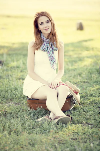 stock image Redhead girl sitting at bag at outdoor.